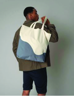 W235 two-tone canvas tote bag in cream and blue, carried by male model – wholesale accessory"